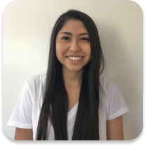 Young adult female smiling in front of a white background