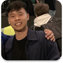 Young adult male in a public setting with an arm around his shoulder