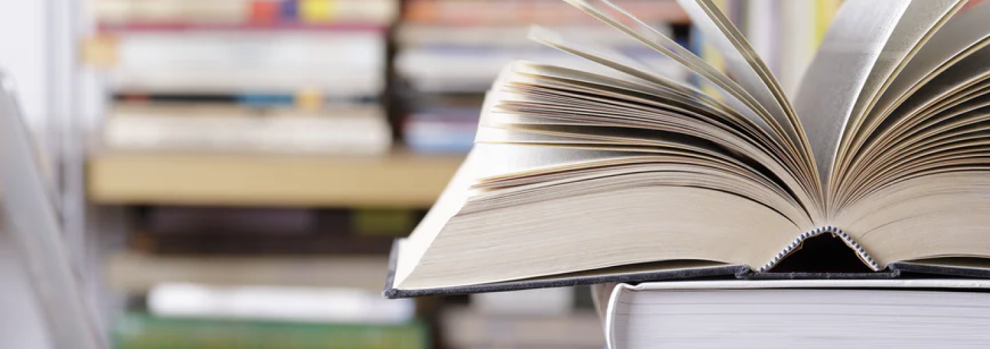 blurred image of a stack of books in a library